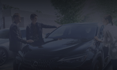 3 people gather around a black NX 250.