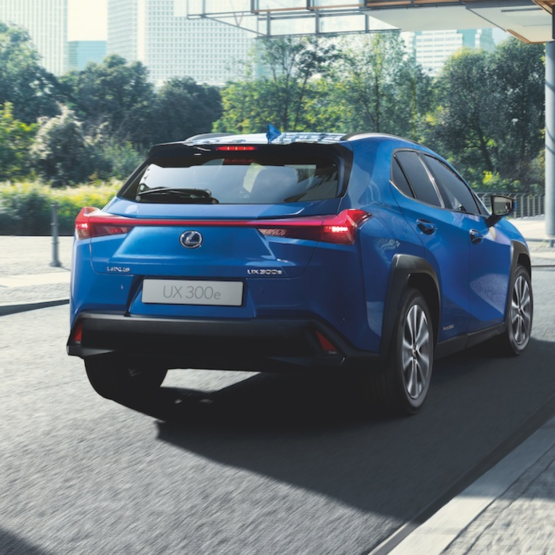 Rear of a blue UX300e driving away down a road