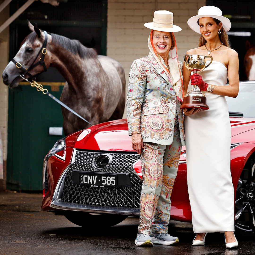 Gai Waterhouse and Kate Waterhouse pose with a a Lexus, horse and the Melbourne Cup trophy.